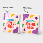 Comparison of glossy and matte finish options for custom vinyl sticker stacks featuring colorful abstract designs.