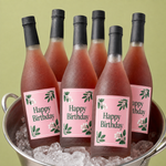 Custom rectangle labels with happy birthday sparkling drink design on glass bottles in an ice bucket