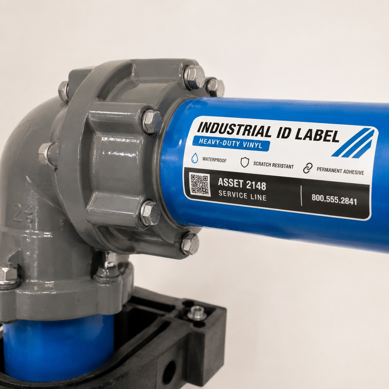 Heavy duty vinyl industrial ID label applied to a blue service line pipe, showing waterproof and scratch resistant properties for asset tracking and identification.