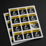 A sheet of premium vinyl heavy duty labels for service access, featuring a yellow and black caution design with a wrench icon, showing one durable sticker being peeled off for industrial equipment maintenance.
