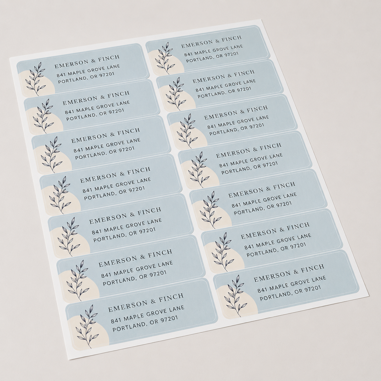 Full sheet of custom return address labels for Emerson and Finch with delicate black leaf illustrations.