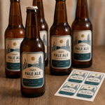 Modern minimalist craft pale ale bottle stickers with a custom printed die-cut label sheet on a wooden background, ideal for microbreweries and homebrewing.