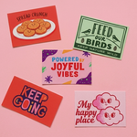 Five motivational custom rectangle stickers with different sayings on a pink background