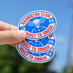 Oval vinyl stickers with a badminton club design held outdoors