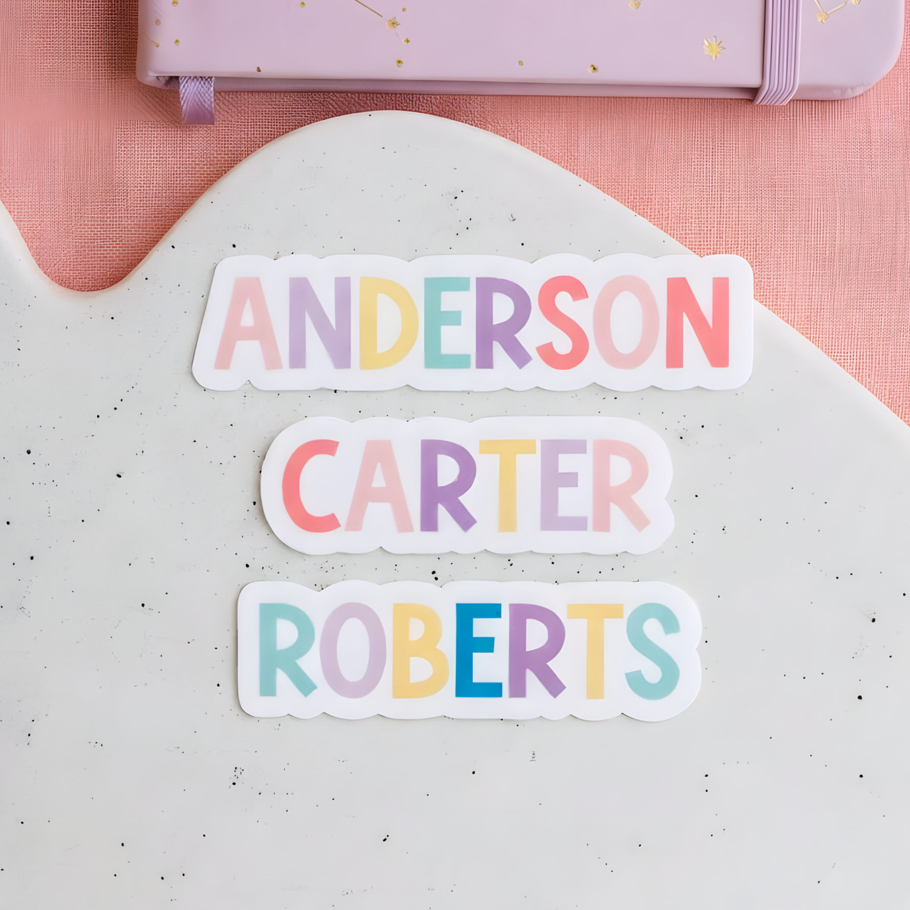 Pastel Anderson, Carter, and Roberts name stickers applied to a white surface.