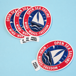 Open Sea Sailing sailboat design peel tab stickers with peel-here tabs arranged on a light blue background.
