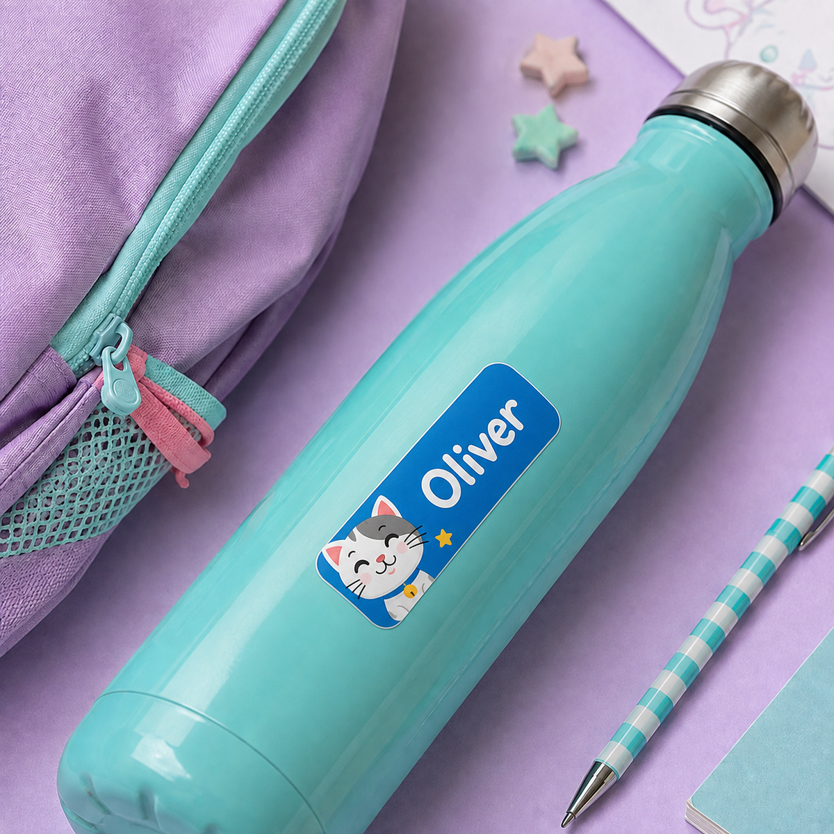 Personalized name sticker on a water bottle with a cute cat design for kids' school supplies