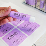 Personalized purple aura lip balm labels shown on a sheet next to a labeled lip balm tube.