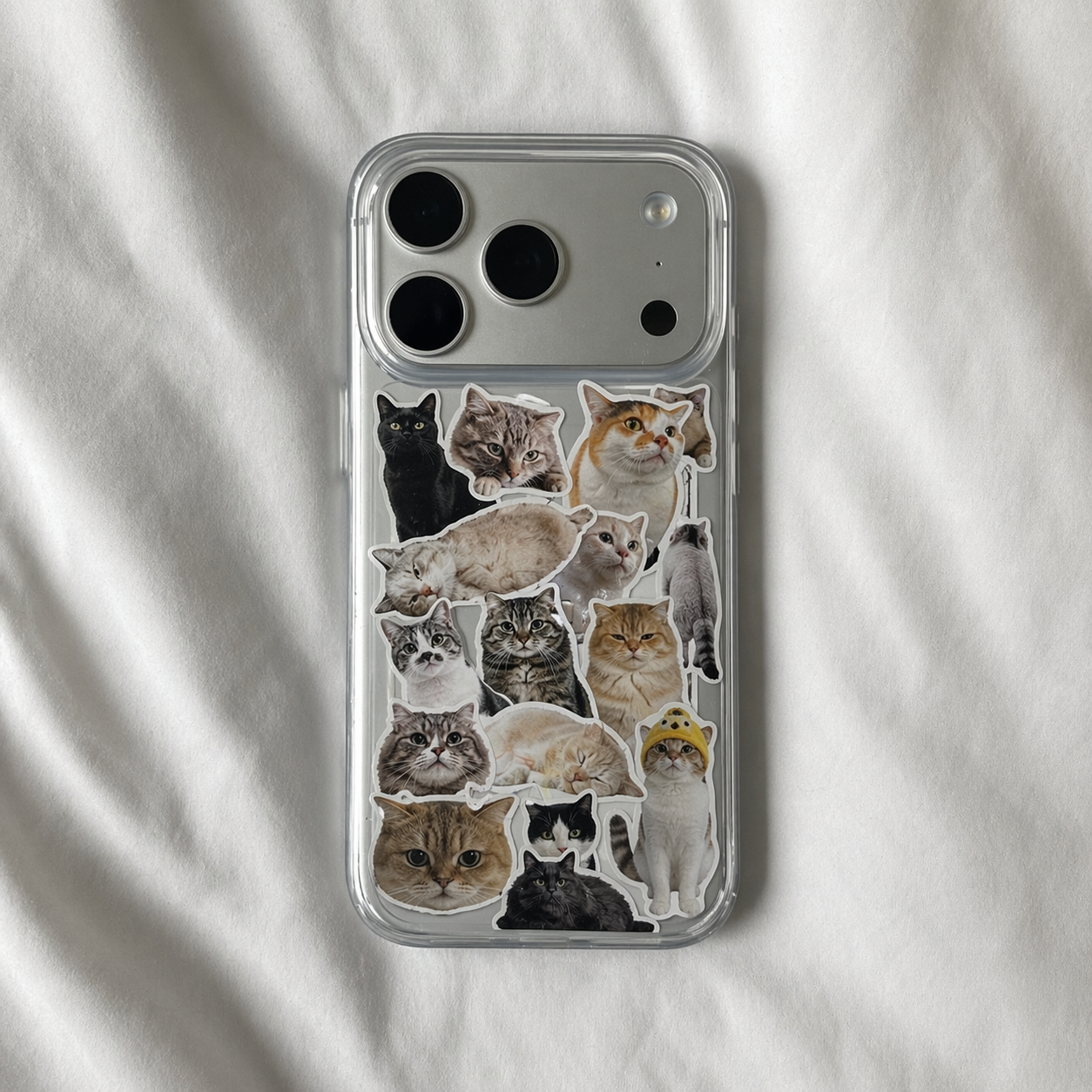 Phone case with personalized cat stickers on a white fabric background