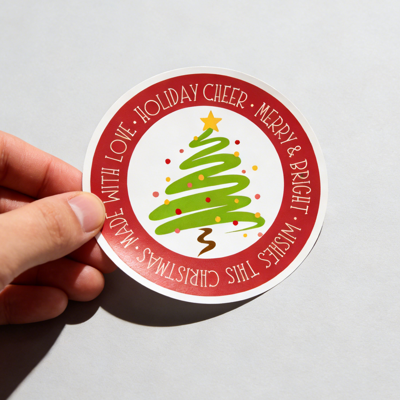 Premium circle vinyl sticker with Christmas tree design, waterproof and scratch-resistant for laptops, water bottles, and outdoor use.