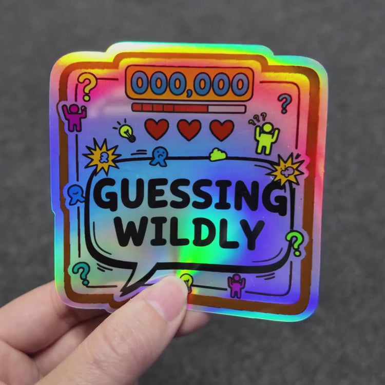 Holographic guessing wildly sticker with rainbow shine effect shown in hand close-up