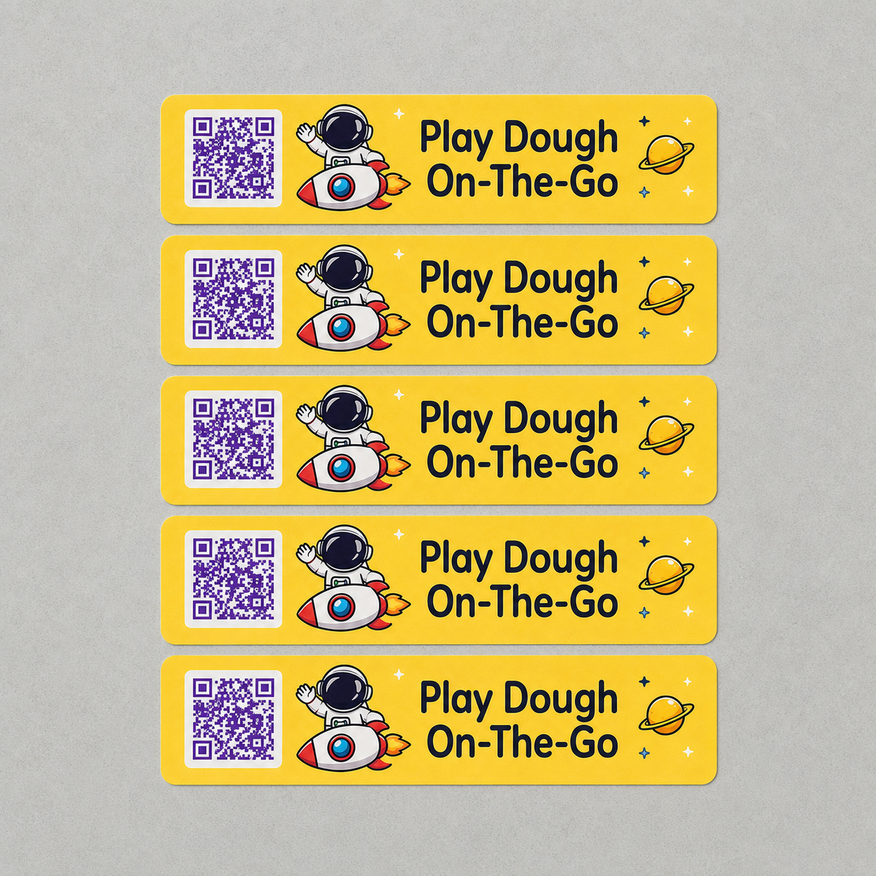 Custom event QR code stickers printed on yellow vinyl labels with astronaut design, rounded corners, and clear scannable QR codes for packaging and branding.
