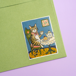 Rectangle sticker with illustrated cat tea party design on a notebook
