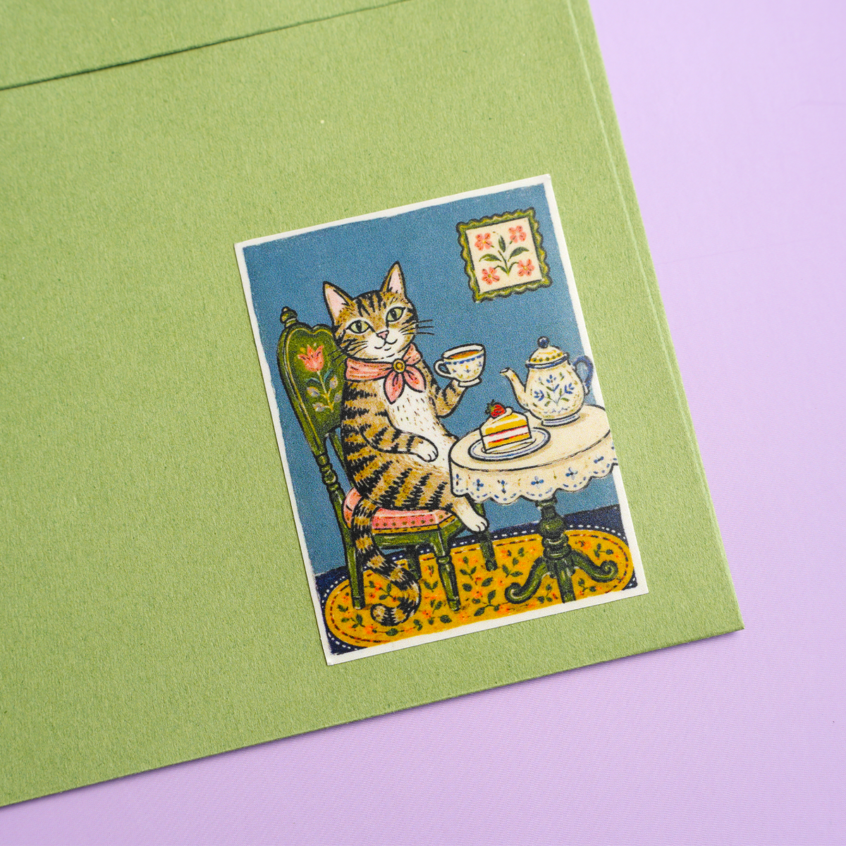 Rectangle sticker with illustrated cat tea party design on a notebook
