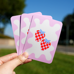Rounded corner square stickers with a cute checkered strawberry design on a pink and white background, showcasing custom rounded corner stickers
