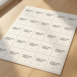 Sheet of 'PURE AND SIMPLE' labels on a wooden surface