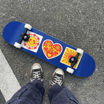 Person standing on a blue skateboard featuring custom sun and heart stickers.