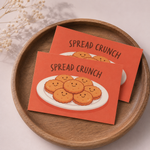 Red rectangle stickers with Spread Crunch cracker illustration on a wooden tray