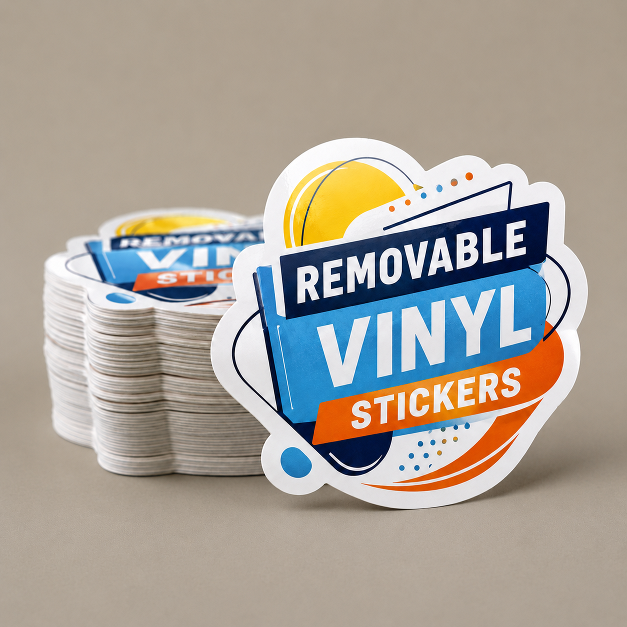 A thick stack of die-cut removable vinyl stickers featuring a colorful design with the text Removable Vinyl Stickers prominently displayed on the front sticker.