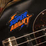 Custom band stickers featuring a bold Super Ability lightning text design on a black electric guitar body.