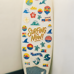 White surfboard featuring a "SURFING NOW!" custom sticker
