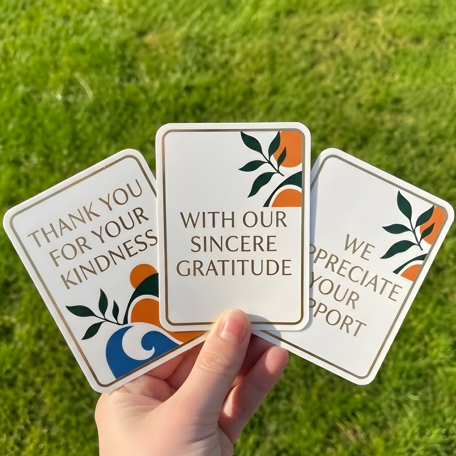 Custom thank you vinyl stickers held by hand, showing appreciation stickers used for small business packaging, orders, and customer experiences.