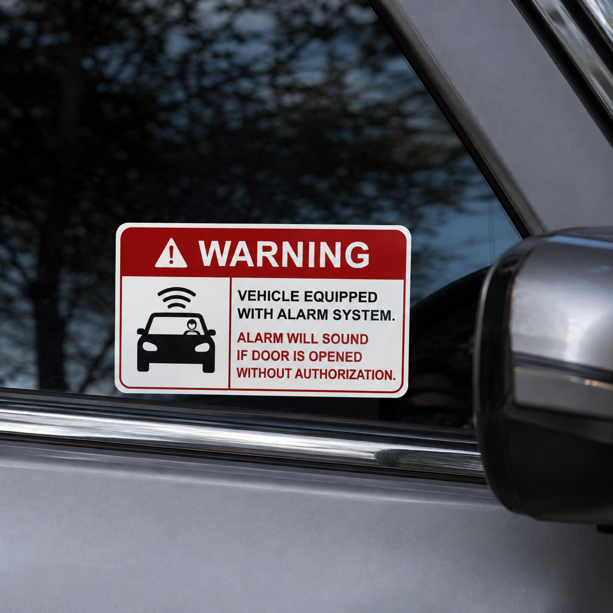 Warning sticker for vehicle equipped with alarm system placed on a car window.