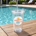 Waterproof summer sticker on a clear tumbler beside a swimming pool.