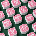 Bulk pink stickers displayed in neat stacks for wholesale orders.