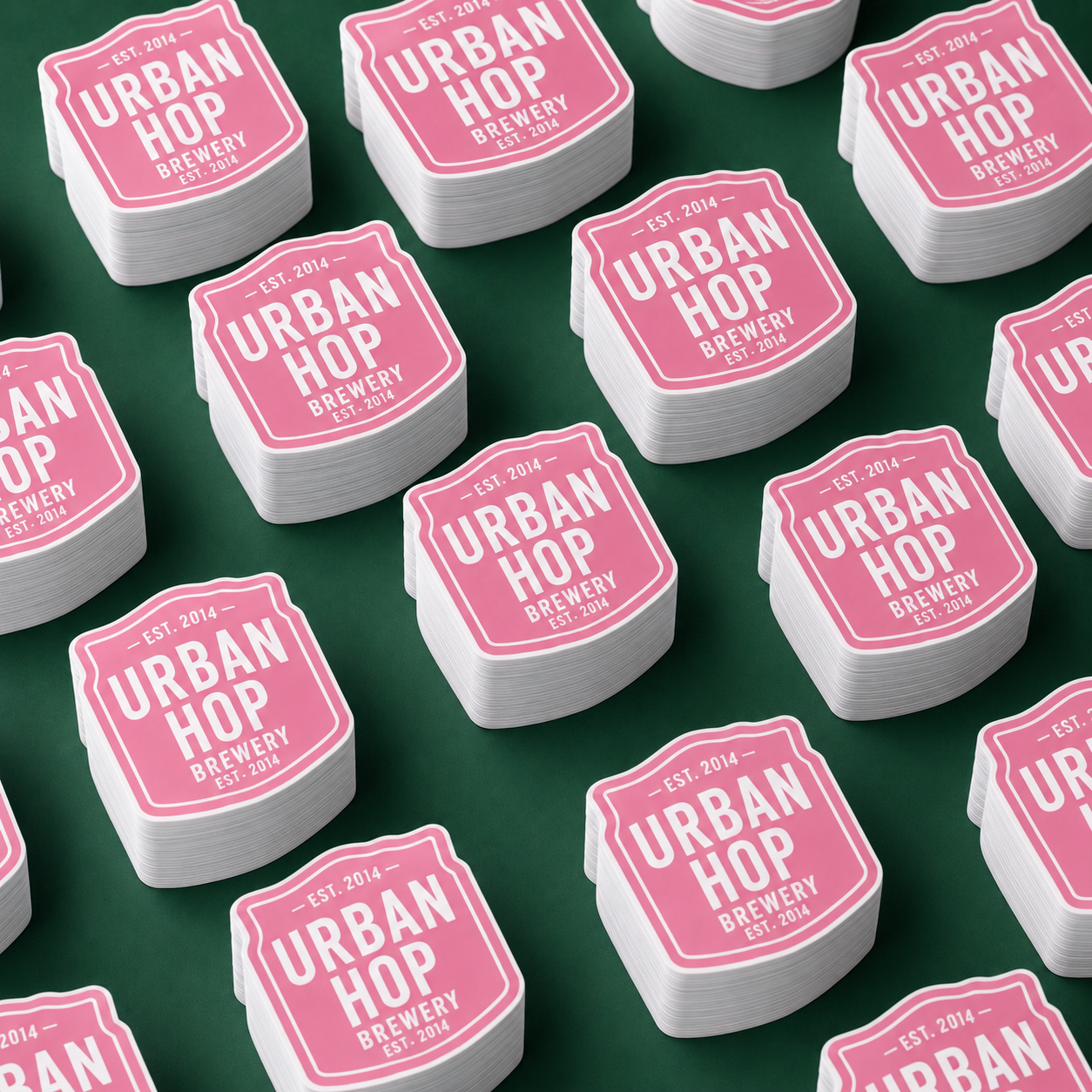 Bulk pink stickers displayed in neat stacks for wholesale orders.